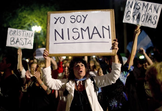 Image: A demonstrator holds a sign that reads in Spanish \"I am Nisman\" during a protest sparked by the death of special prosecutor Alberto Nisman, outside the government house in Plaza de Mayo in Buenos Aires, Argentina
