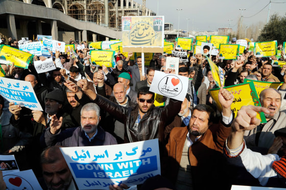 epa04578552 Iranians hold placards reading in Farsi 'Muhammad, we sacrifice our lives for you' during a demonstration condemning decision by controversial French magazine, Charlie Hebdo, to publish a depiction of the Prophet Muhammad, follwoing Friday prayers, Tehran, Iran, 23 January 2015. According to local reports demonstrators once again took to streets shouting slogans such as "We love Muhammad" and "Down with the Zionist France" even as the Iranian Government condemned the attack on the offices of Charlie Hebdo which left 12 members of staff dead, but also criticised the publication's choice to publish depictions of the Prophet, which in many modern interpretations of Islam is considered to be forbidden. EPA/ABEDIN TAHERKENAREH