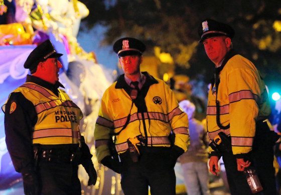 Image: A float passes New Orleans police officers on Thursday
