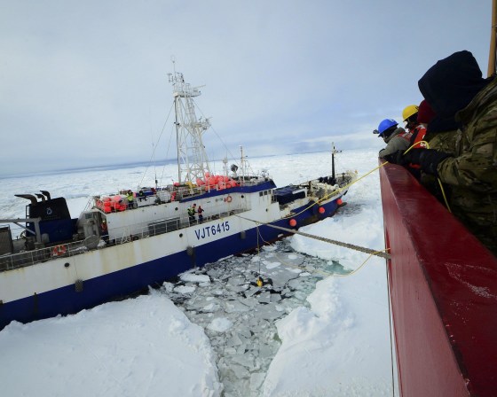 Image: Members of the military dive team aboard Coast Guard cutter, Polar Star, launch a remote operated vehicle into the water to inspect the disabled fishing vessel Antarctic Chieftain, beset by ice near Cape Burks