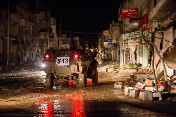 Image: Turkish army vehicles drive in a street of the Syrian town of Kobane.