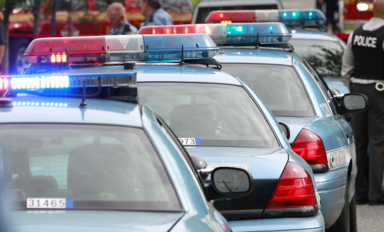 Seattle Police carls lines up at the scene of a crime.