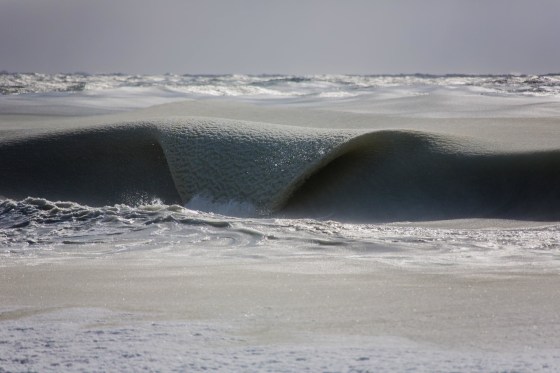 A wave, thick with ice, rolls into a beach on Nantucket, Massachusetts.