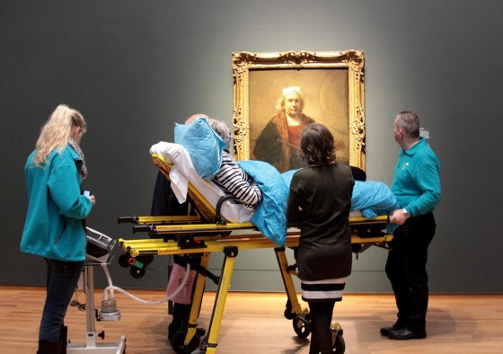 A terminally ill woman looks at a self-portrait by Rembrandt at Amsterdam’s Rijksmuseum.