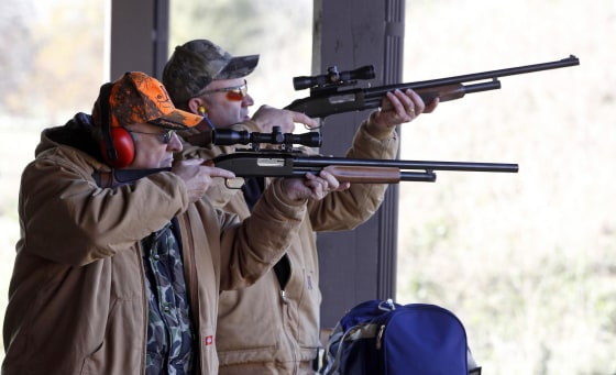Hunters fire their gun during a sighting in and test-firing of shotguns and rifles in a safe environment at the Illinois State Police firing range in Joliet