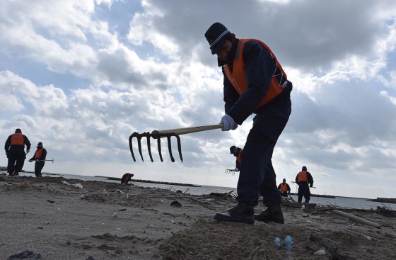 Image: Police search for Japan Tsunami victims