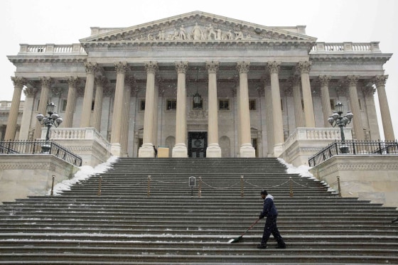 Image: An Architect of the Capitol staff clears snow from the steps of the Senate Chamber at the U.S. Capitol in Washington