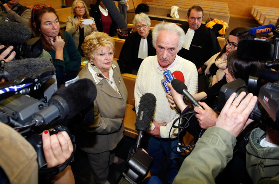 Pierre Le Guennec (R) and his wife Danielle (L) are surrounded by the media following the verdict of their trial at the courthouse in Grasse, southeastern France on Friday.