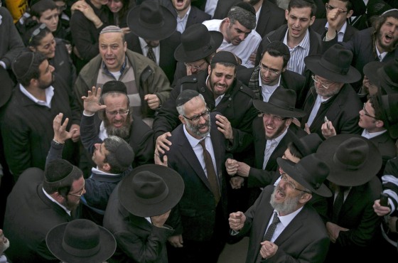 Image: Gabriel Sassoon attends the burial ceremony for his seven children in Jerusalem