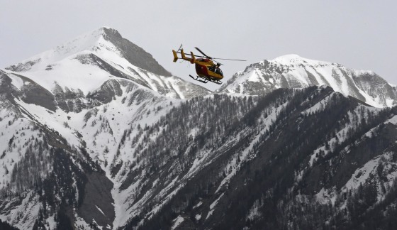 Image: A rescue helicopter from the French Securite Civile flies over the French Alps during a rescue operation following the crash of an Airbus A320