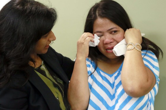 Gina Pablo (right), one of the 11 workers suing L'Amande bakery, is consoled by litigation director Laboni Hoq during a news conference at Asian Americans Advancing Justice in Los Angeles on Thursday, March 19, 2015.