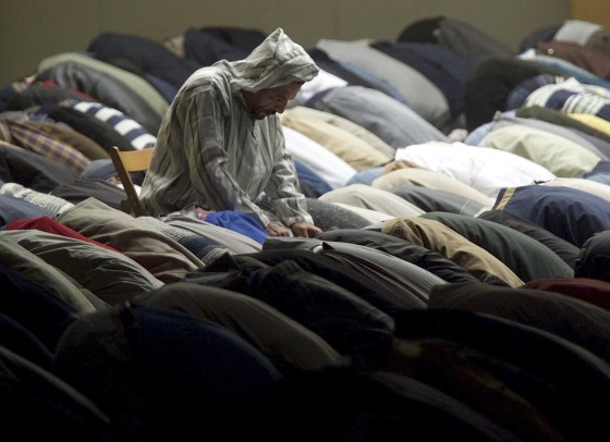 Image: File photo of Muslims praying during Friday prayers outside Milan's mosque