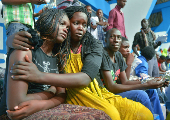 Image: A survivor of an attack by islamist gunmen claimed by al Shabab on a university campus in Garissa, northern Kenya is comforted by a colleague