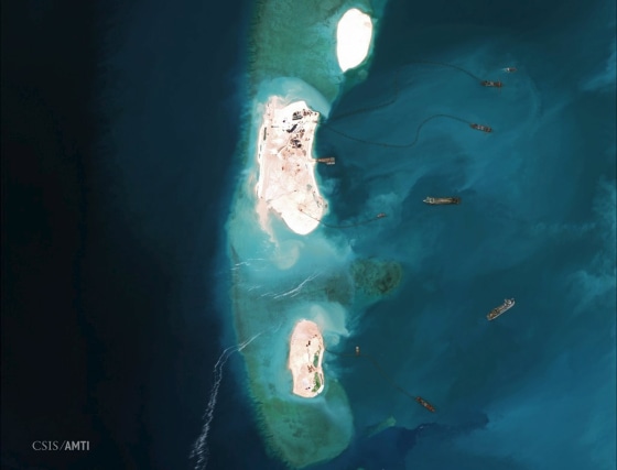 Image: Satellite image of dredgers reinforcing a site being constructed by China on the westernmost part of Mischief Reef