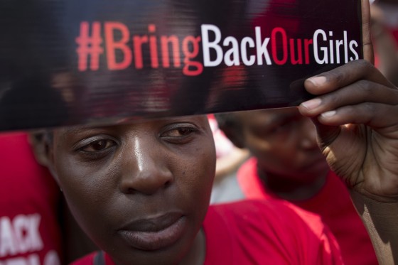 A Kenyan activist looks on as she holds up a placard during a demonstration to protest against kidnapping of Nigerian school girls by Nigeria's Islamist militant group Boko Haram, in Nairobi, Kenya, 15 May 2014