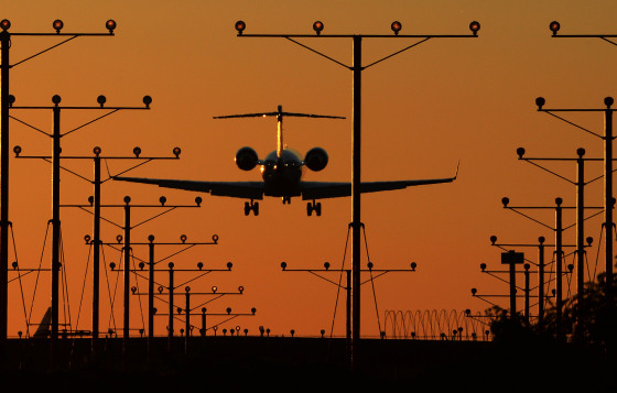 Image: A plane comes in for a landing at LAX at dusk.