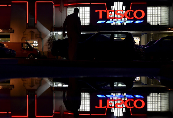 Image: File photo of a shopper entering a branch of Tesco supermarket in west London