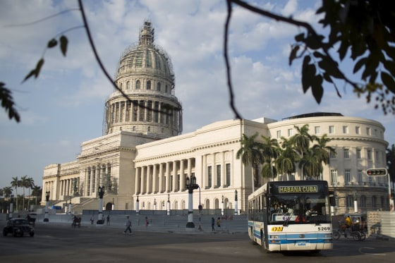 Image: A public bus passes by the Capitol in Havana