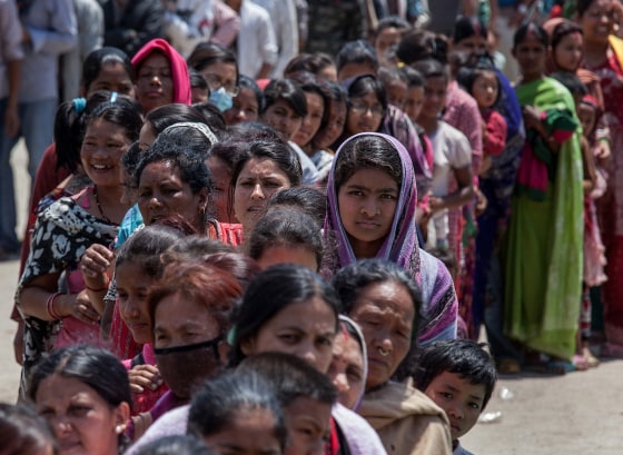 Residents line up for food in an evacuation area set up by the authorities in Tundhikel park on April 27, in Kathmandu, Nepal. A major 7.8 earthquake hit Kathmandu mid-day on Saturday, and was followed by multiple aftershocks that triggered avalanches on Mt. Everest that buried mountain climbers in their base camps. Many houses, buildings and temples in the capital were destroyed during the earthquake, leaving thousands dead and many more trapped under the debris as emergency rescue workers attempt to clear debris and find survivors.