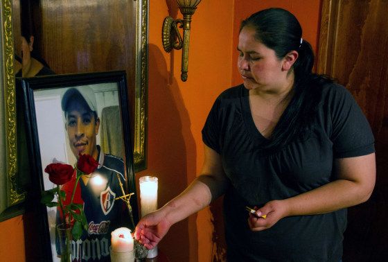 The sister of Mexican Ruben García Villalpando --who was fatally shot by a police officer in Tarrant County, TX, lights a candle next to a portrait of her brother at her house, in the town of Nuevo Porvenir, in Durango State on February 28 2015.