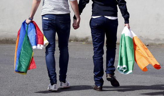 Image: A couple walks hand in hand from the count center in Dublin as Ireland holds a referendum on gay marriage