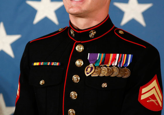 A retired U.S. Marine Corps Corporal stands before receiving the Medal of Honor from U.S. President Barack Obama on June 19, 2014