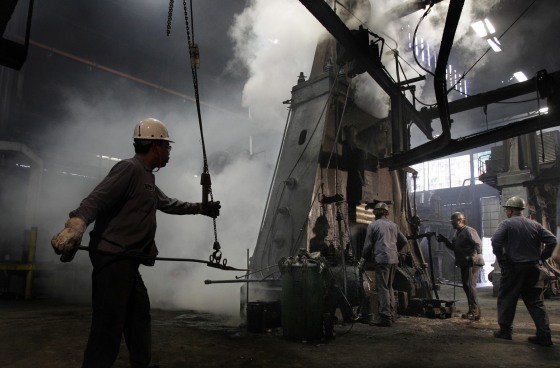 In this Oct. 18, 2010 photo, workers get ready to pull a piece of forged steel to be used in a heavy load helicopter out of a giant press at SifCo Industries in Cleveland, Ohio. Manufacturing activity expanded last month at the fastest pace since May due to a surge in new orders and production. (AP Photo/Amy Sancetta)