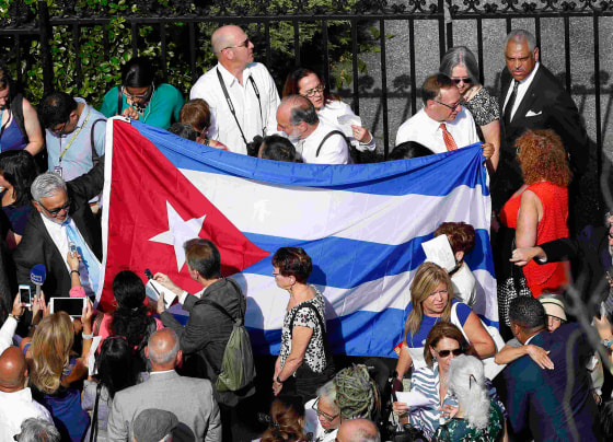 Image: Cuban flag is carried by people before embassy reopening in Washington