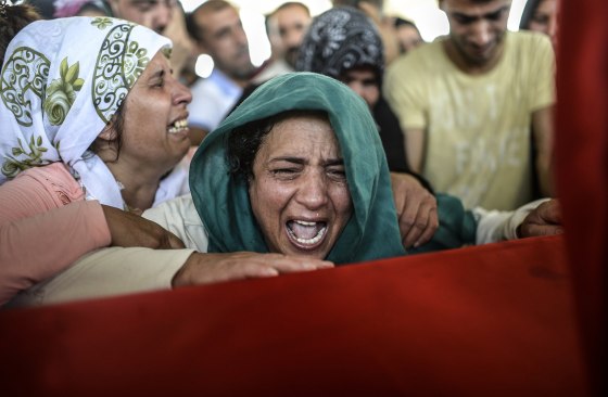 The mother of a victim cries for her son on his coffin during a funeral ceremony in Gaziantep on July 21. 