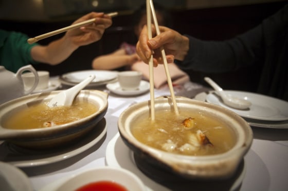A family eats shark fin soup at Vancouver's Grand Honor Chinese restaurant in Vancouver, British Columbia July 1, 2012.