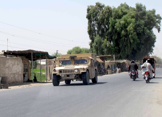 Image: Afghan National Police armored vehicle patrols on a street in Lashkar Gah capital of Helmand