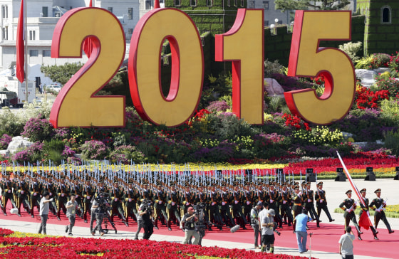 Image: Soldiers of People's Liberation Army (PLA) of China walk past a sign of 2015 as they attend a flag-raising ceremony at the beginning of the military parade marking the 70th anniversary of the end of World War Two, in Beijing