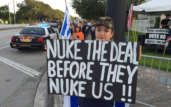 Image: Protester holds sign before U.S. Vice President Biden met with Jewish community leaders at David Posnack Jewish Community Center in Davie