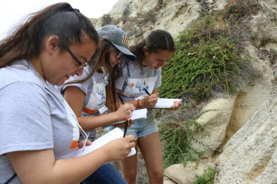 High school students with the GEAR UP program at California State University, Fullerton, participated in a two-week summer program focused on California geology. As part of the program, students traveled to San Clemente State Beach and Dana Point in southern California to make observations and take measurements of the rocks and the ocean.