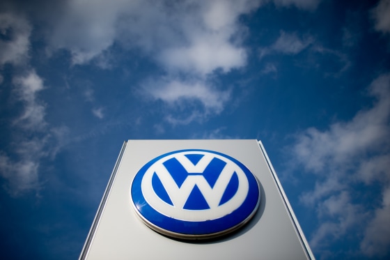 A sign with the Volkswagen logo stands in front of a VW car dealer in Hanover, Germany, in 2014. 