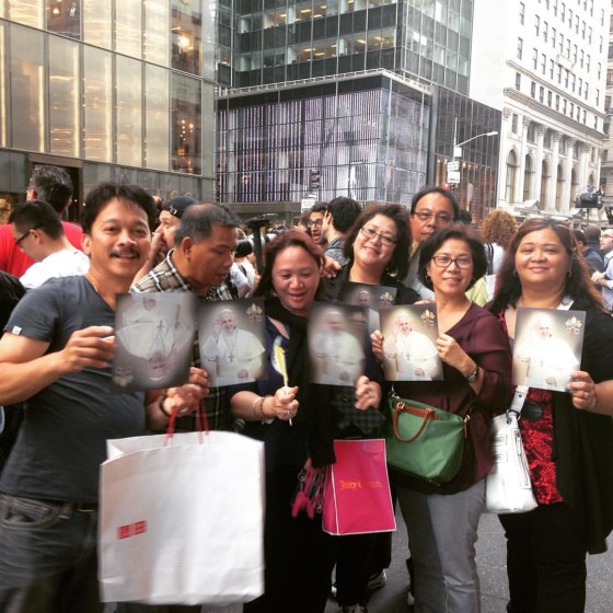 Filipino-American Catholics from churches on Long Island pose on Fifth Avenue with photos of Pope Francis on Thursday, September 24, 2015.