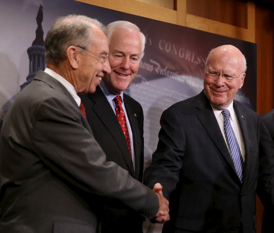 Image: Senators Grassley, Cornyn and Leahy shake hands at news conference on criminal justice reform in Washington