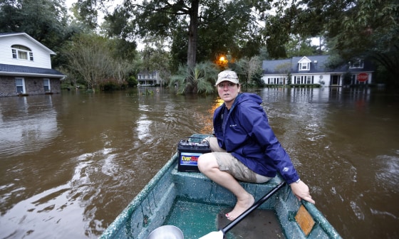 Image: South Carolina woman checks on flooded neighbors