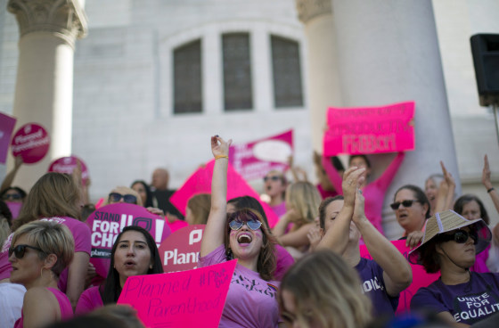 Image: Activist Weismer chants during a rally in support of Planned Parenthood on \"National Pink Out Day\" on the steps of City Hall in Los Angeles