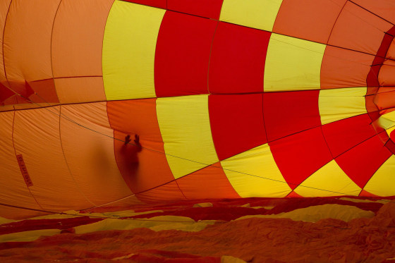 Image: An attendee touches the outside of an inflating hot air balloon during the 2015 Albuquerque International Balloon Fiesta in Albuquerque, New Mexico
