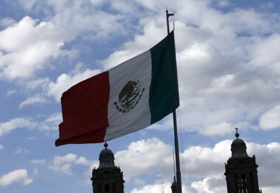 Image: Mexico's flag flutters next to the Metropolitan Cathedral at Zocalo Square in Mexico City