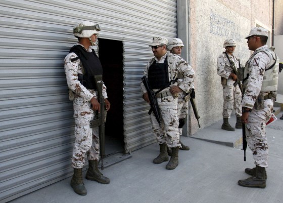 Image: Soldiers of the Mexican Army stand guard outside a warehouse containing a tunnel discovered by Mexican Army, in Tijuana
