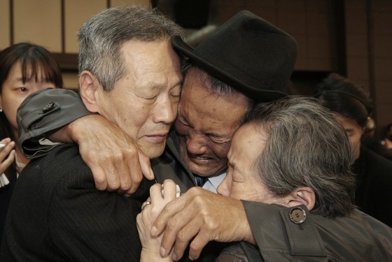 Image: North Korean Son Kwon Geun, center, weeps with his South Korean relatives
