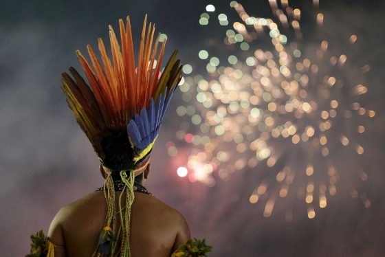 Image: An indigenous man watches fireworks during the first World Games for Indigenous Peoples in Palmas