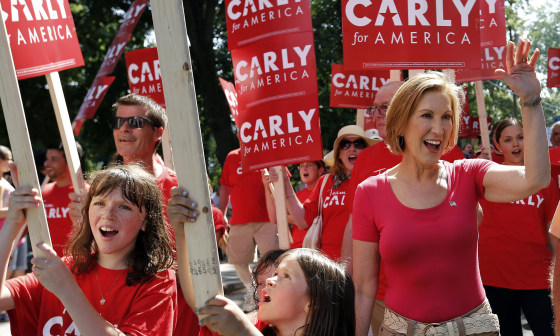 Image: Carly Fiorina waves during a Labor Day parade