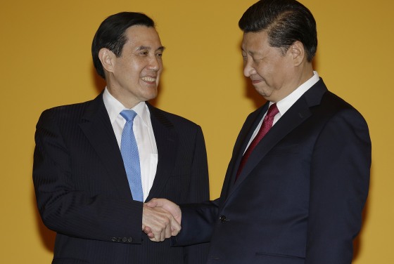 Chinese President Xi Jinping, right, and Taiwanese President Ma Ying-jeou, left, shake hands at the Shangri-la Hotel on Saturday, Nov. 7, 2015, in Singapore. The two leaders shook hands at the start of a historic meeting marking the first top level contact between the formerly bitter Cold War goes since they split amid civil war 66 years ago.