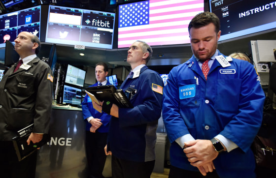 Image: Traders pause for a moment of silence for Paris attack victims at the New York Stock Exchange.