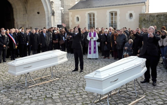 Image: Pallbearers release doves at the funeral of two sisters