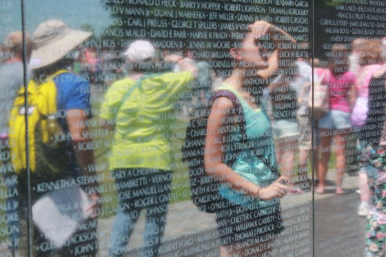 Jacqueline Mac, one of the project's narrators, observing the Vietnam Veterans Memorial in Washington, D.C.