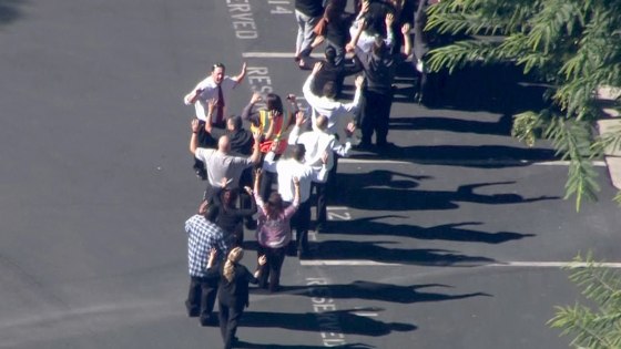 People being lead away from the Inland Regional Center.
